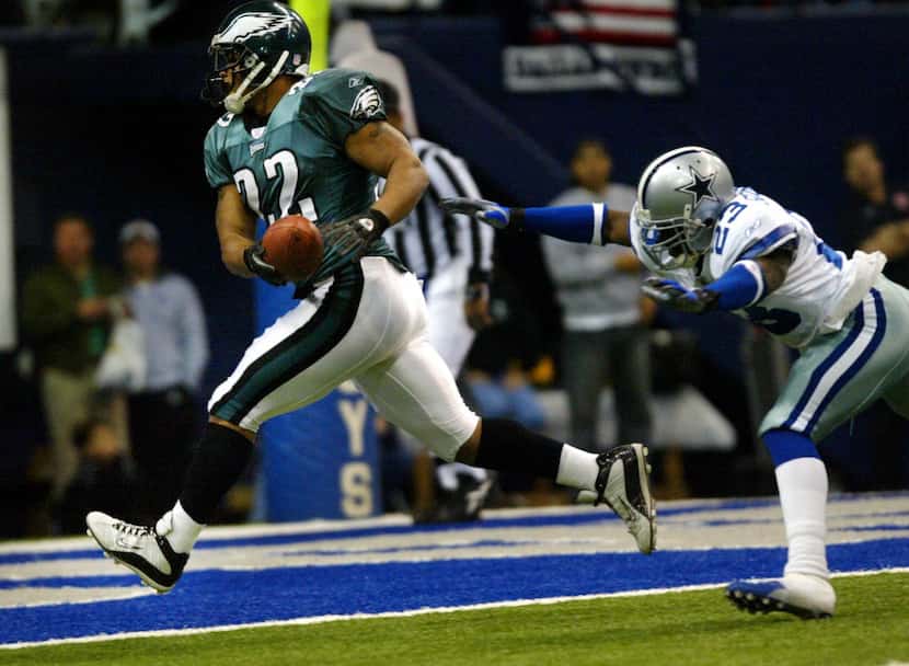 Eagles Duce Staley trots in for an Eagles touchdown as Cowboys Dwayne Goodrich dives but can...