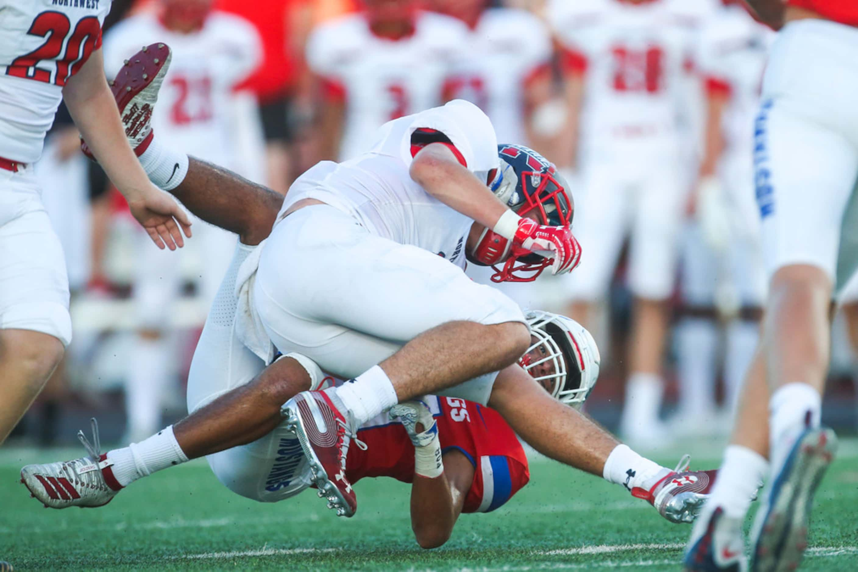 Grapevine defensive back Adriene White (21) brings down Northwest's Weldon Sherrell (6)...