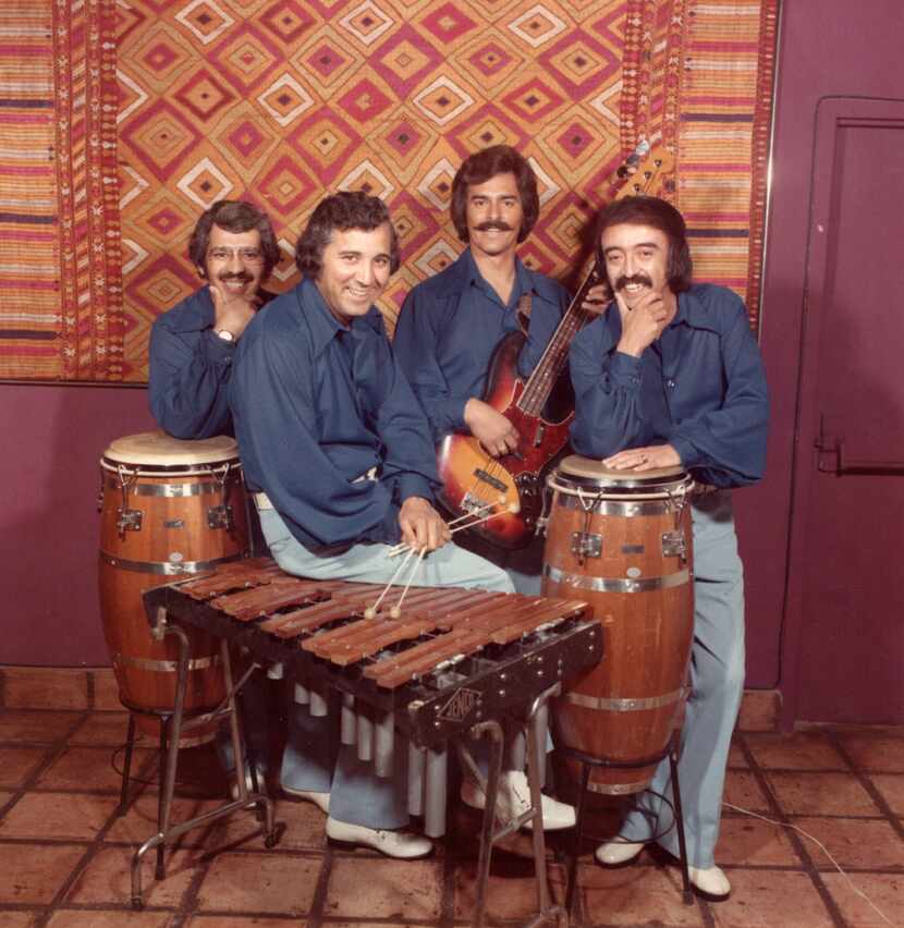 Henry Muñoz sitting on a marimba with his band in the summer of 1975. Muñoz grew up in...