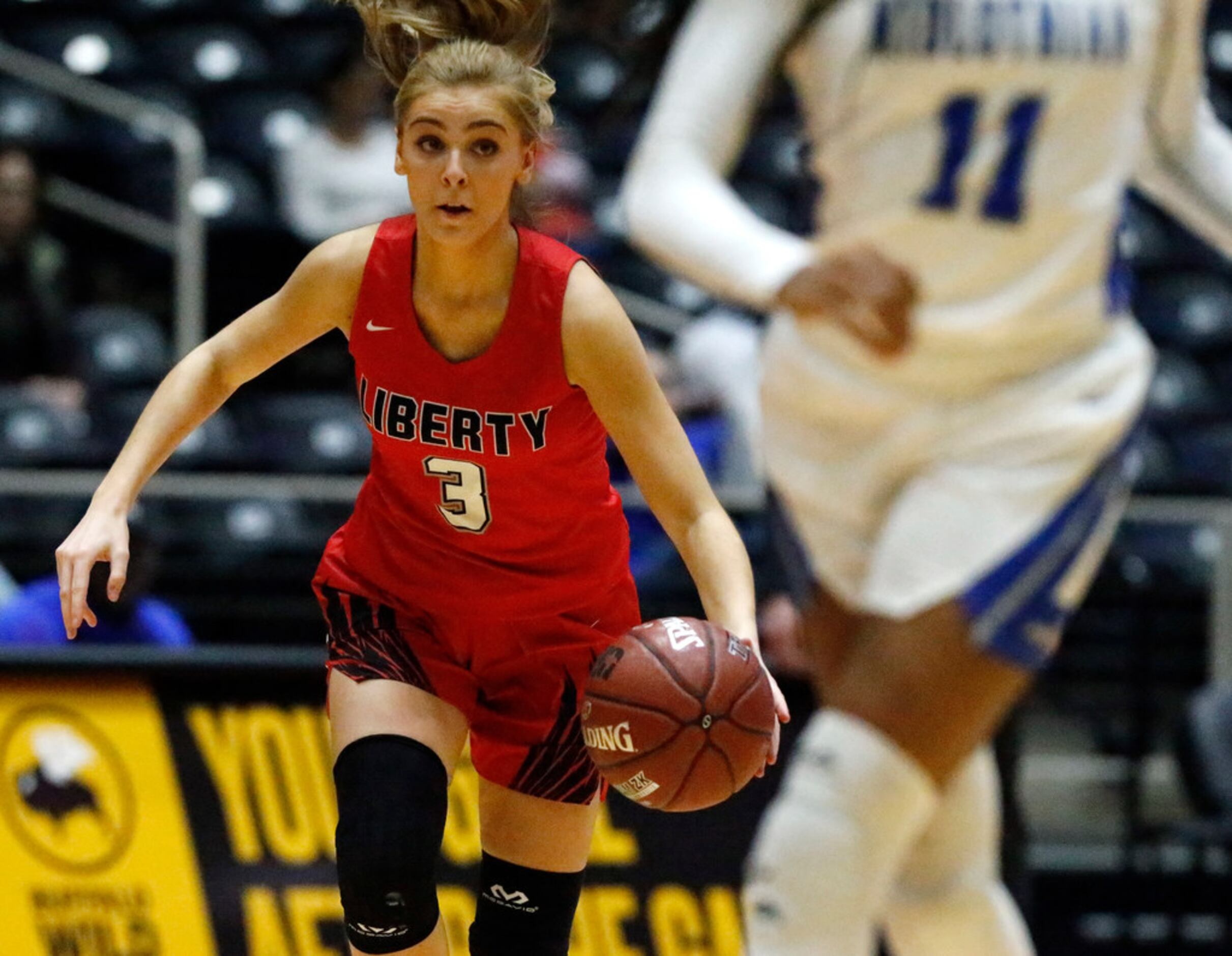 Frisco Liberty High School guard Lily Ziemkiewicz (3) brings the ball up the floor during...