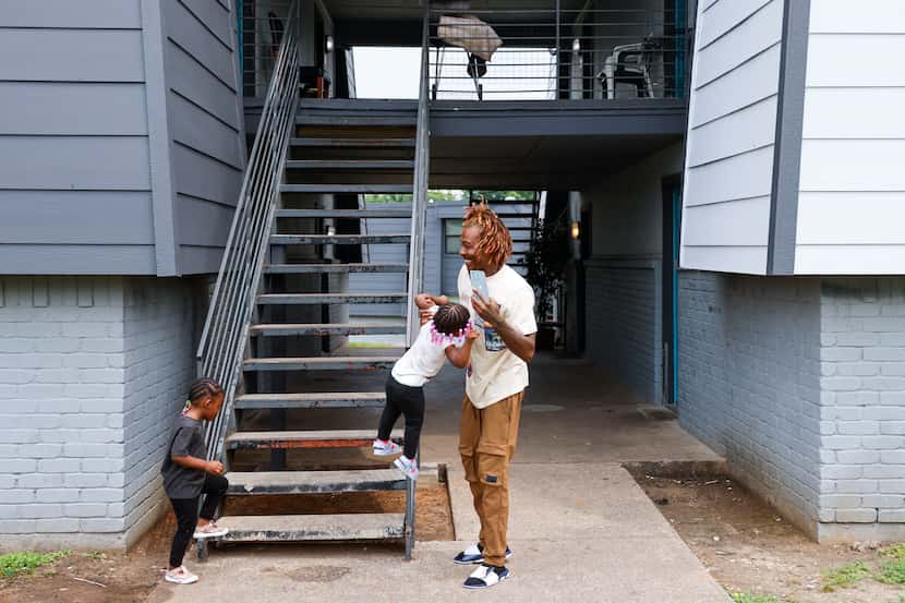 Veon Alexander, whose family has lived at the Volara Apartments for 18 months, picks up his...