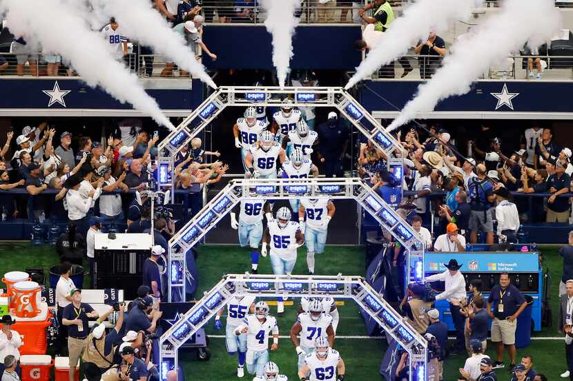 The Dallas Cowboys run onto the field for their home opener against the New York Jets at...