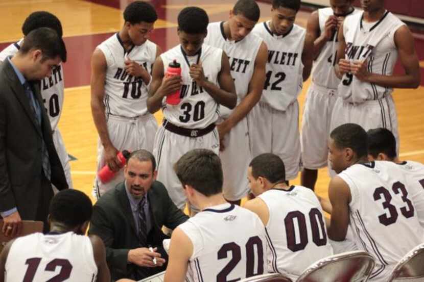 Jason Busch instructs his team between quarters of a Jan. 4 win over Garland Naaman Forest....