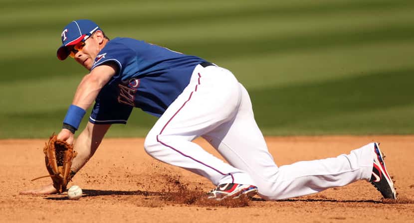 Texas Rangers third baseman Michael Young (10) fails to catch a hard line drive during their...