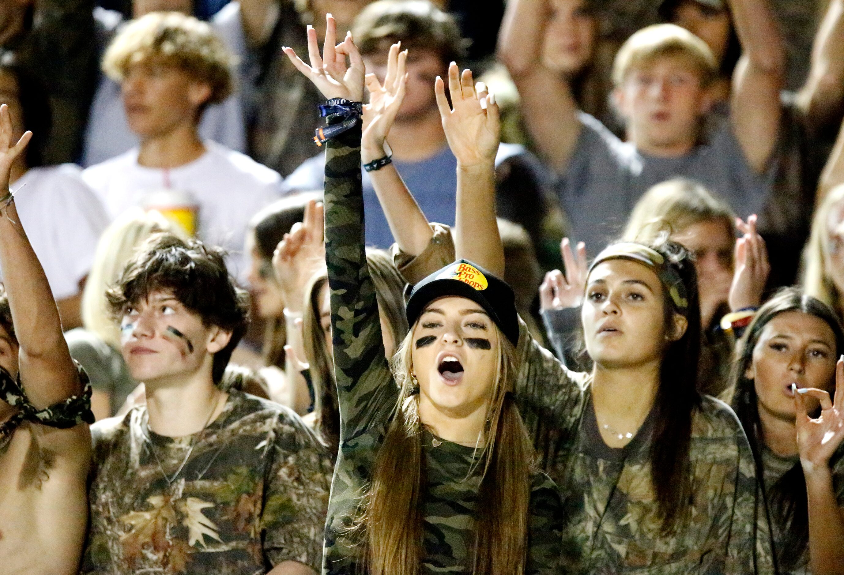 Flower Mound High School student Kallie Basil, 17, signals third down during a defensive...