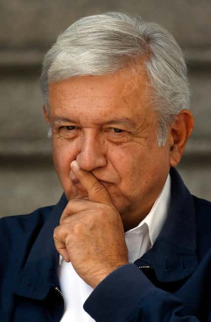 Mexico's President-elect Andres Manuel Lopez Obrador paused as he met with media outside his...