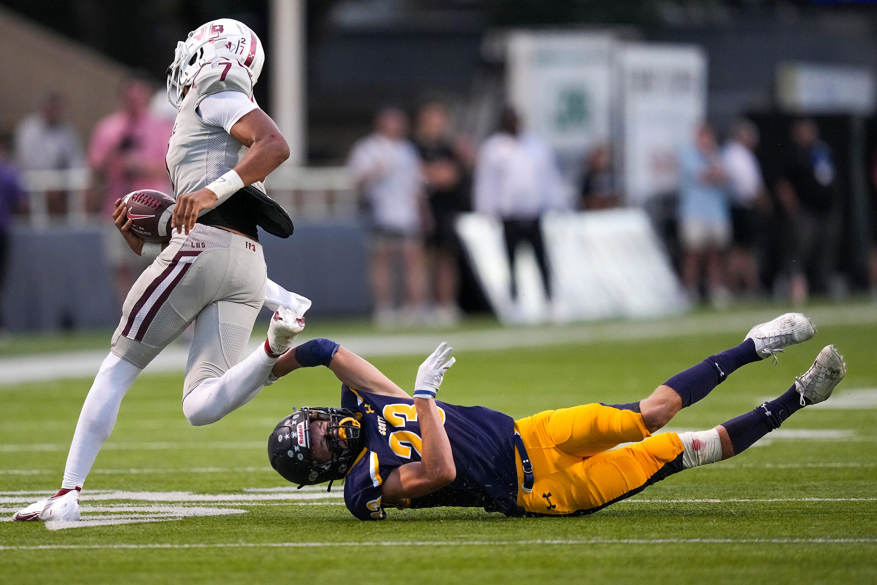 Lewisville quarterback Ethan Terrell (7) gets past Highland Park cornerback Jack McCallum...