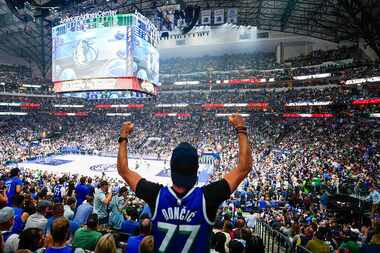 Fans cheer a basket by Dallas Mavericks guard Luka Doncic during the first half in Game 4 of...