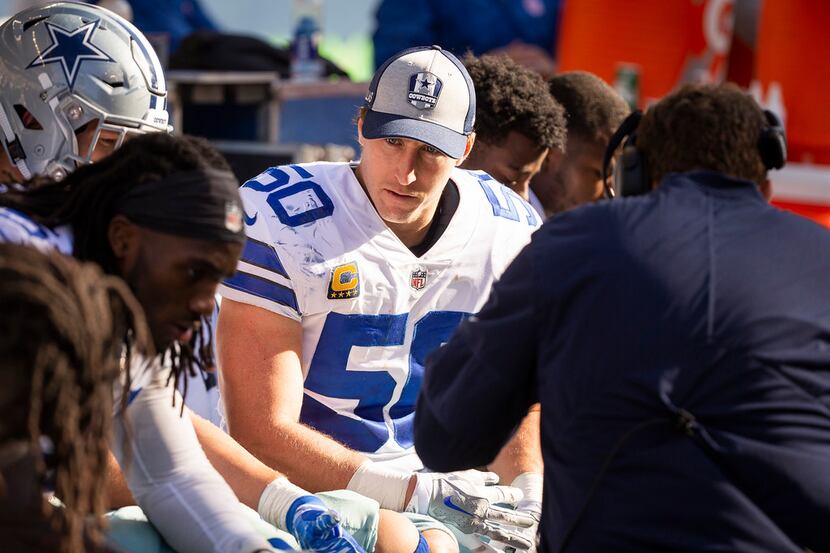 Dallas Cowboys linebacker Sean Lee talks to teammates on the bench during the second half of...