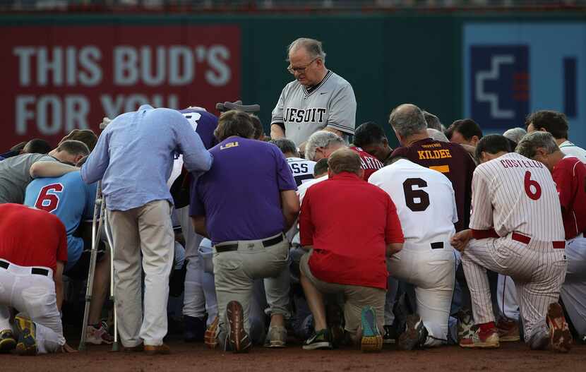 U.S. House Chaplain the Rev. Patrick J. Conroy leads a prayer for the players during the...