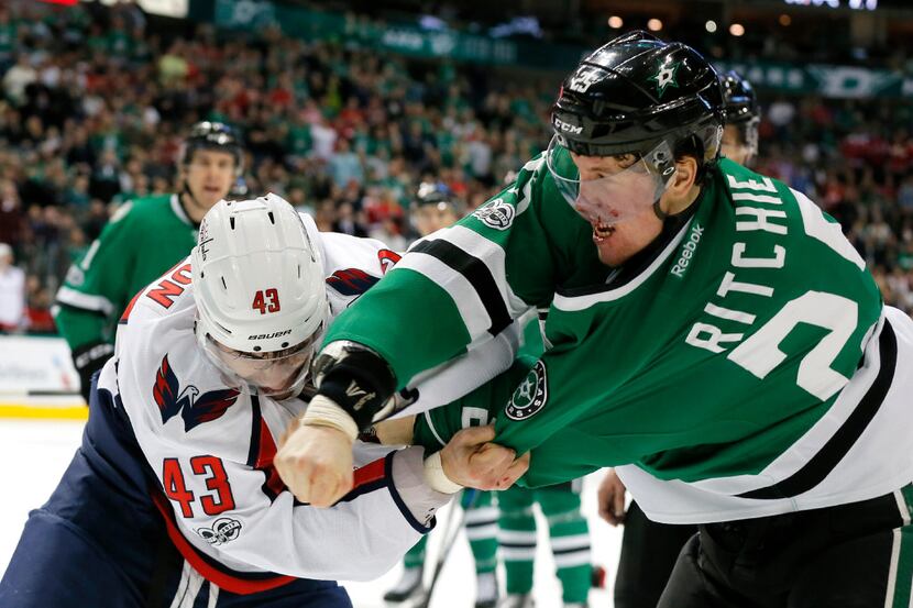 Dallas Stars' Brett Ritchie (25) bleeds on his mask after being punched in the face by...