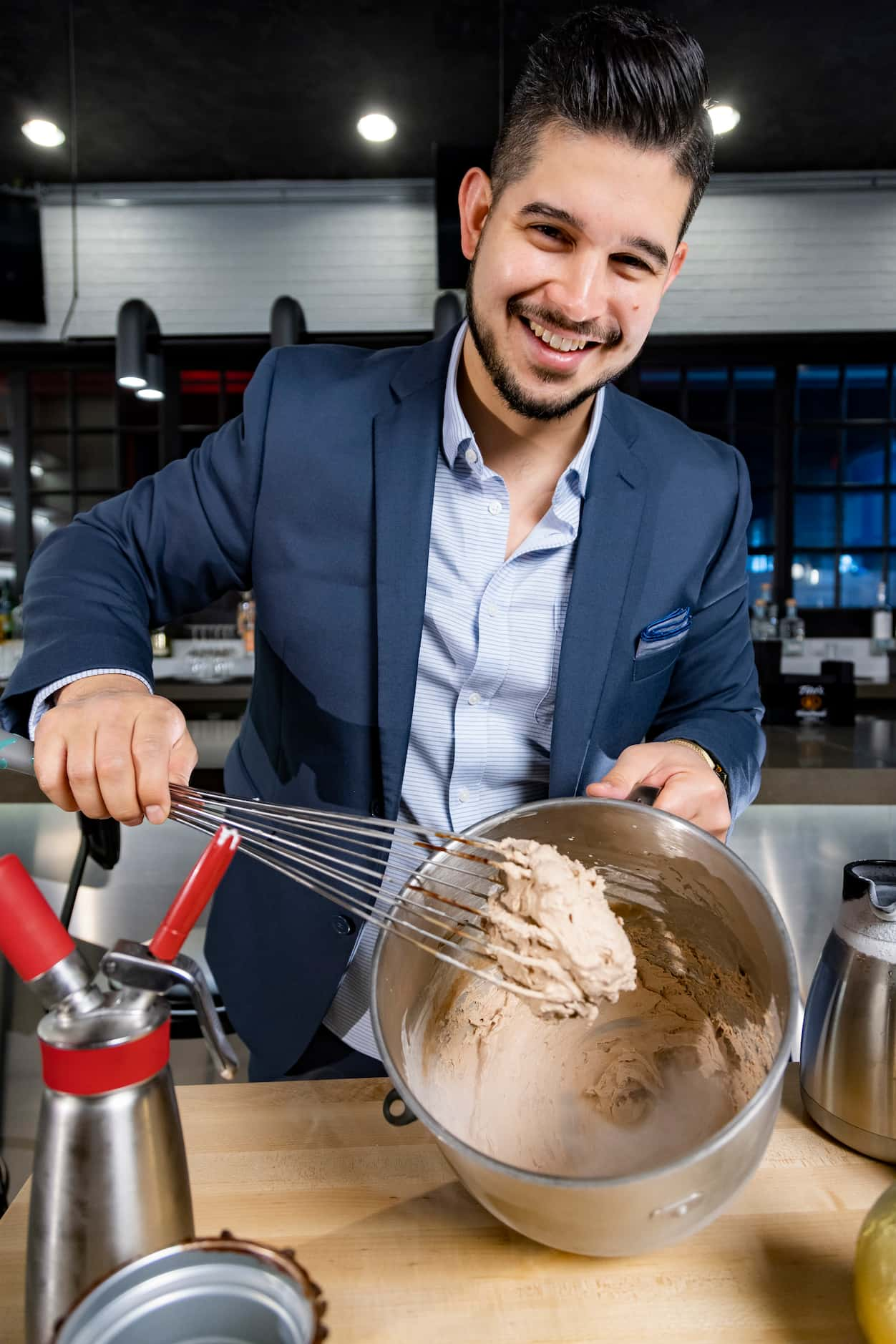 Julian Rodarte, CEO of Trinity Groves and Co-Owner of Nitro Burger, shows off a batch of...