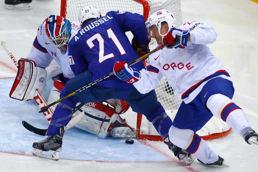 Norway's Mats Trygg, right, lars Haugen, left, and France's Antoine Roussel battle for the...
