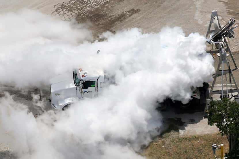 A mixture of nitrogen gas and water vapor engulfs a truck at the Martin Marietta plant after...