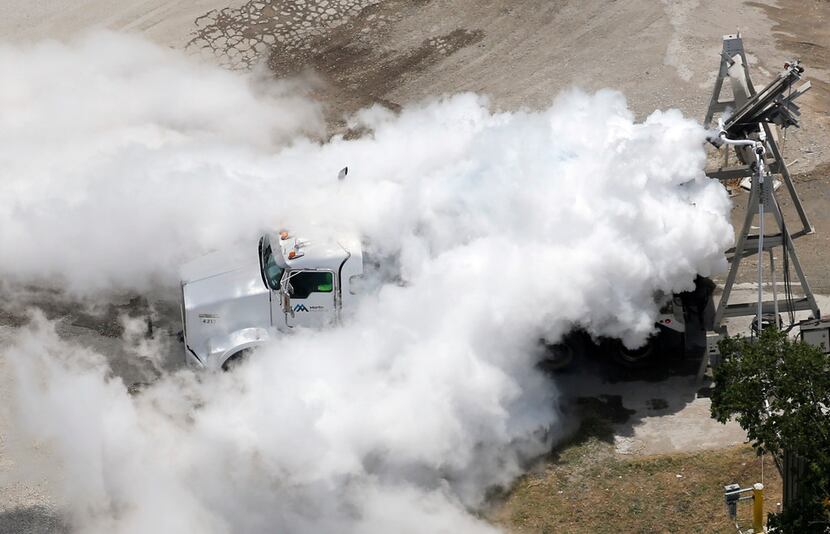 A mixture of nitrogen gas and water vapor engulfs a truck at the Martin Marietta plant after...