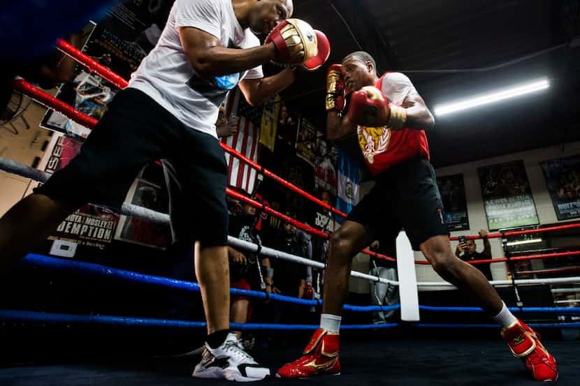 FILE - Errol Spence Jr. works out with his trainer, Derrick James, on Tuesday, April 25,...