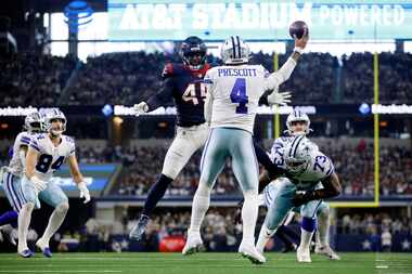 Dallas Cowboys quarterback Dak Prescott (4) throws a pass around Houston Texans linebacker...