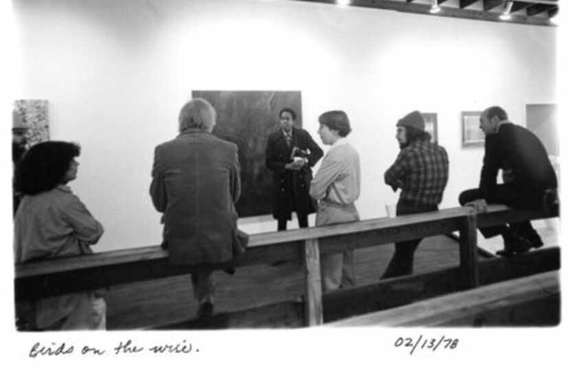 A group of gallery members leans and sits against a railing inside 500X Gallery in 1978, the...