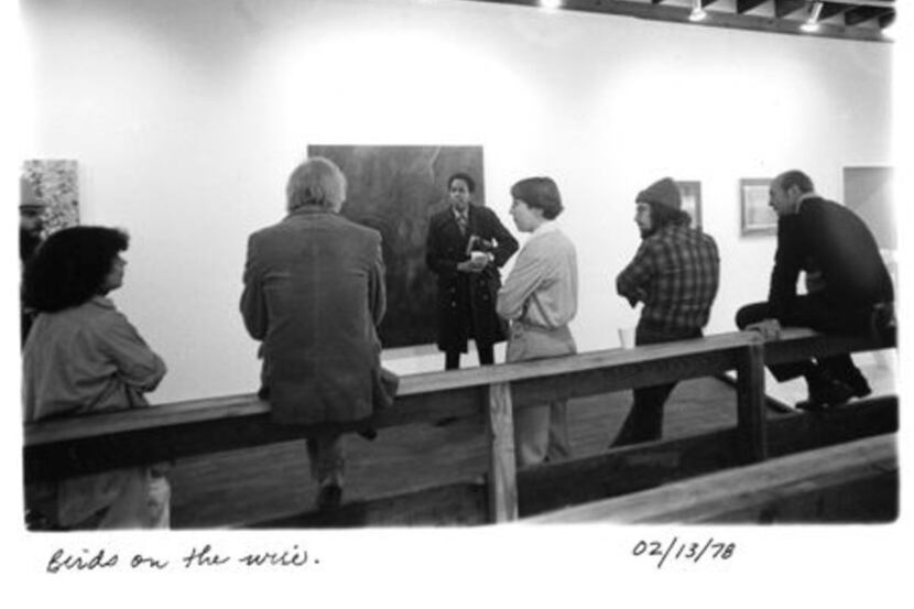 Gallery members lean and sit against a railing inside 500X Gallery in 1978, the year the...