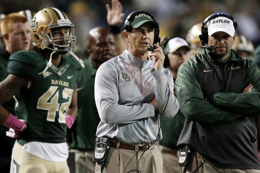 FILE - In this Oct. 19, 2013, file photo, Baylor head coach Art Briles, center, watches...