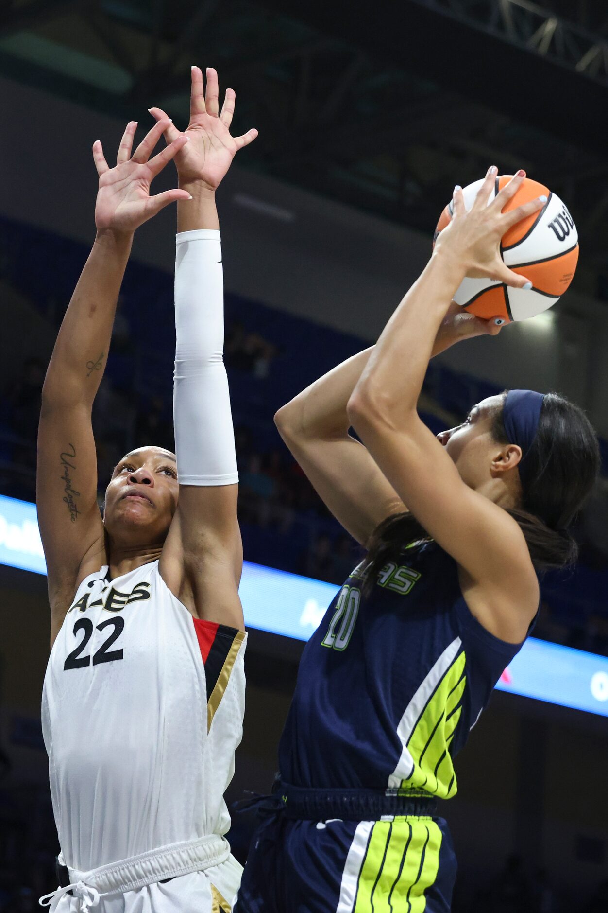 Las Vegas Aces forward A'ja Wilson (22) attempts to block a shot from Dallas Wings forward...