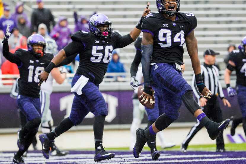 TCU defensive end Josh Carraway (94) celebrates after recovering a fumble and running it in...
