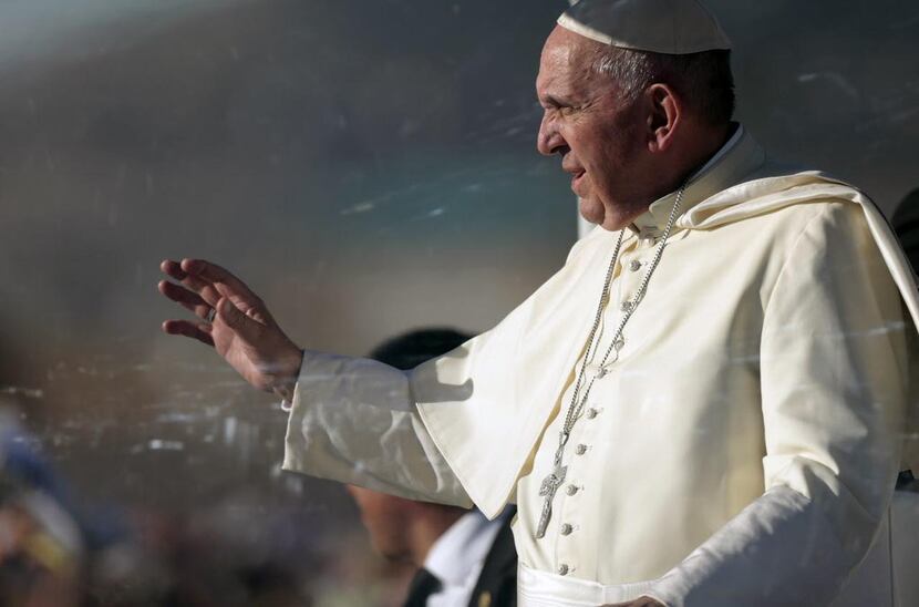
Pope Francis waves from the popemobile in Ciudad Juarez, Mexico. Throngs gathered at...