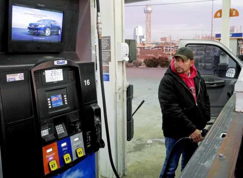 
Jesus Herrera watches the gas pump, which is filling up tanks at prices not seen in years....