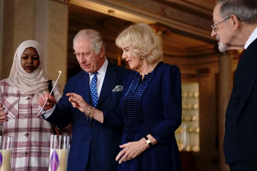 Britain's King Charles III and Camilla, the Queen Consort light two candles at Buckingham...