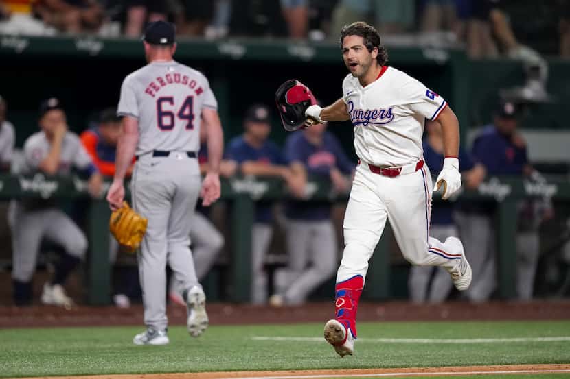 Texas Rangers' Josh Smith, right, runs the bases after hitting a two-run walkoff home run...