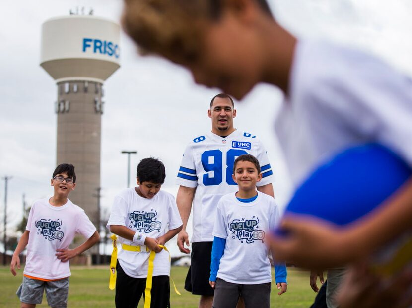 Dallas Cowboys defensive lineman Tyrone Crawford plays flag football and nutrition games...