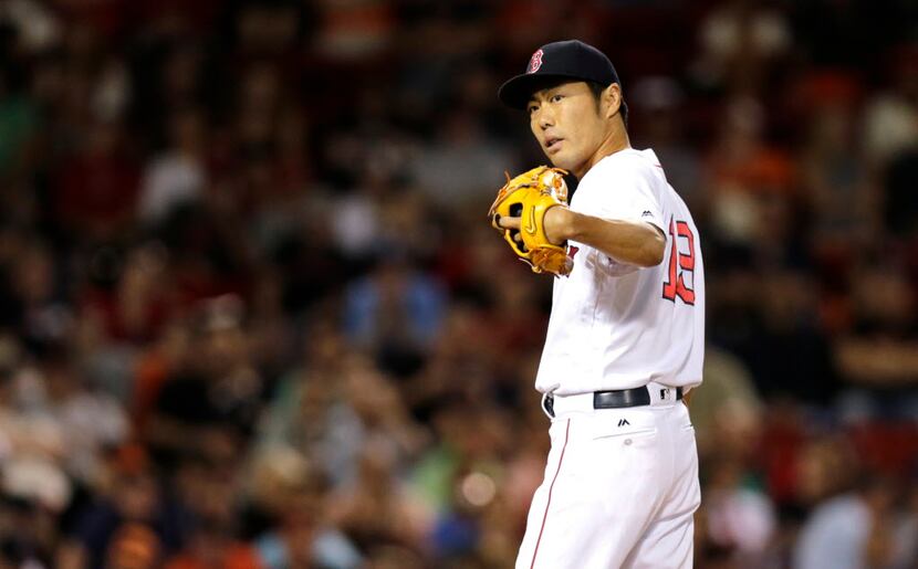 Boston Red Sox relief pitcher Koji Uehara calls for the medical staff to visit the mound...