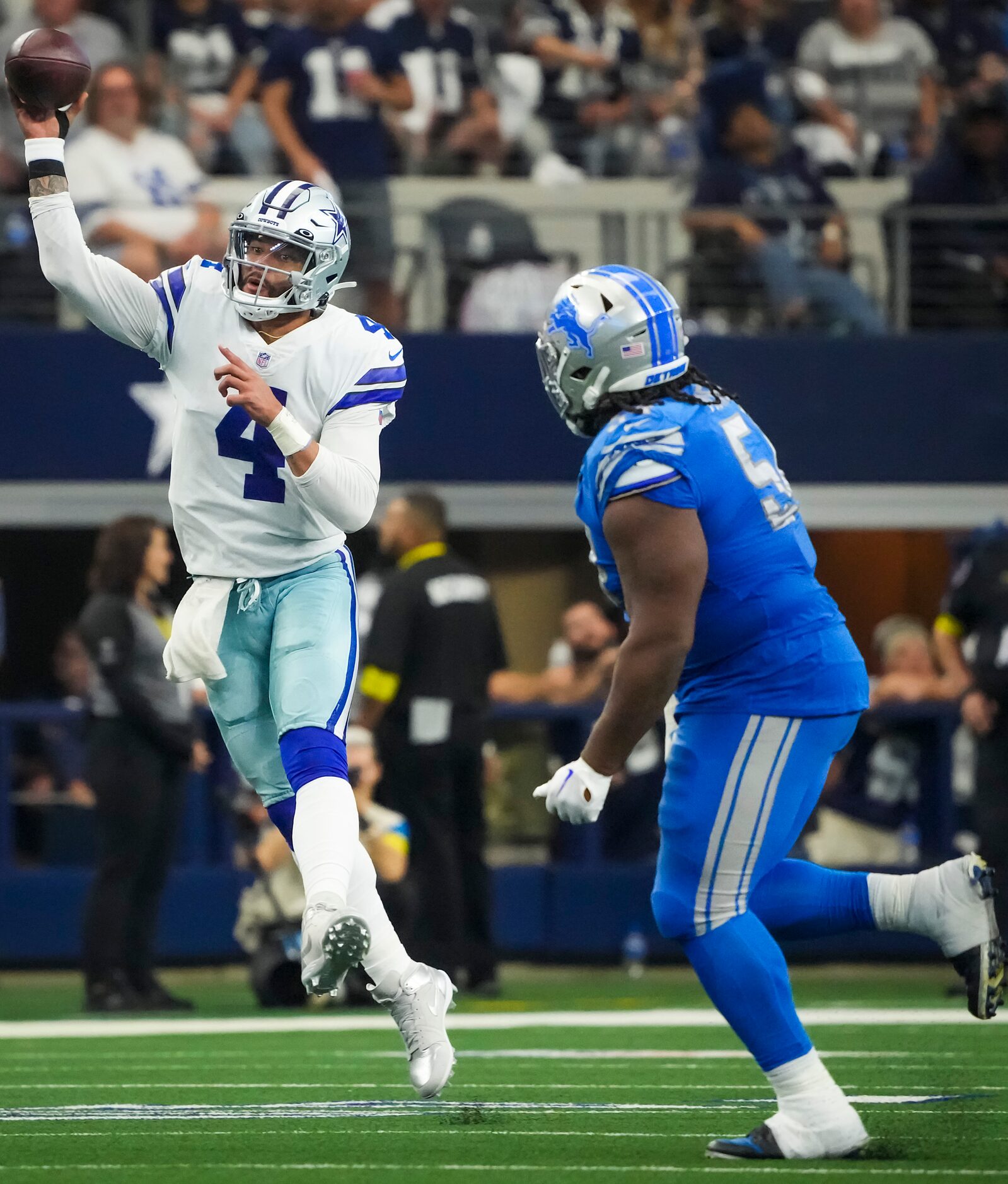 Dallas Cowboys quarterback Dak Prescott (4) throws a pass as he scrambles away from Detroit...