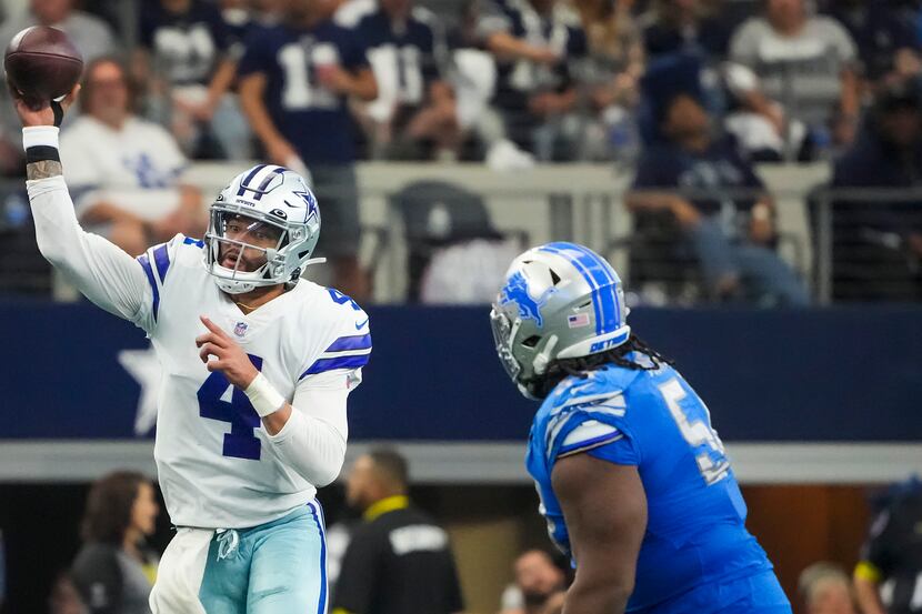 Dallas Cowboys quarterback Dak Prescott (4) throws a pass as he scrambles away from Detroit...