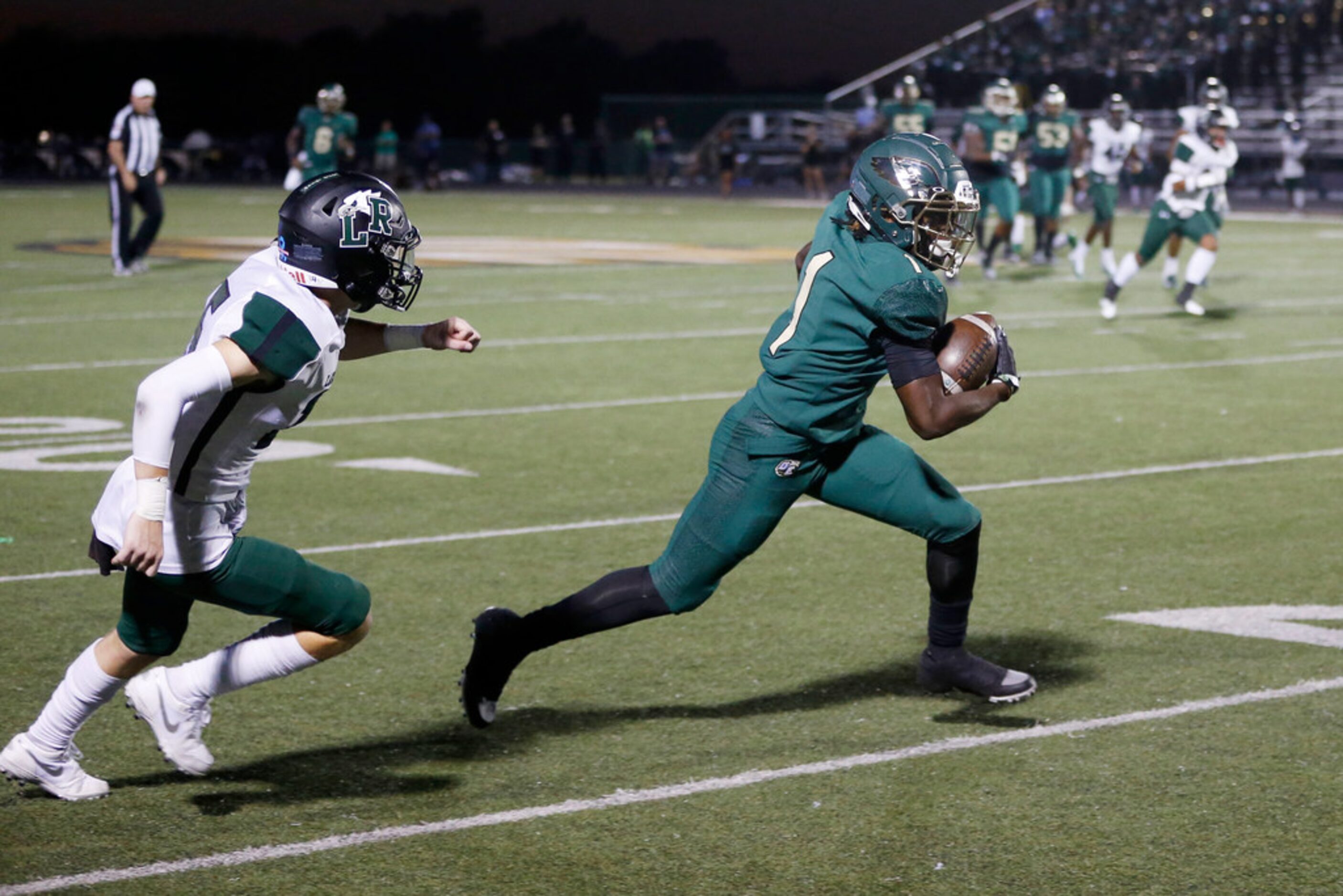 DeSoto Eagles Jordan Brown (1) keeps his feet in bounds as he turns in to pass Mansfield...