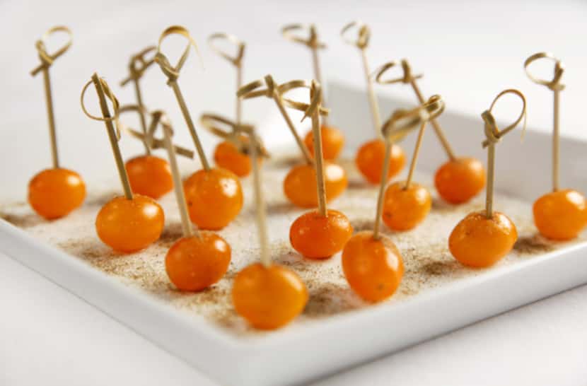 You want simple, no-mess foods, such as Vodka Tomatoes With Celery Salt. Square plate from...