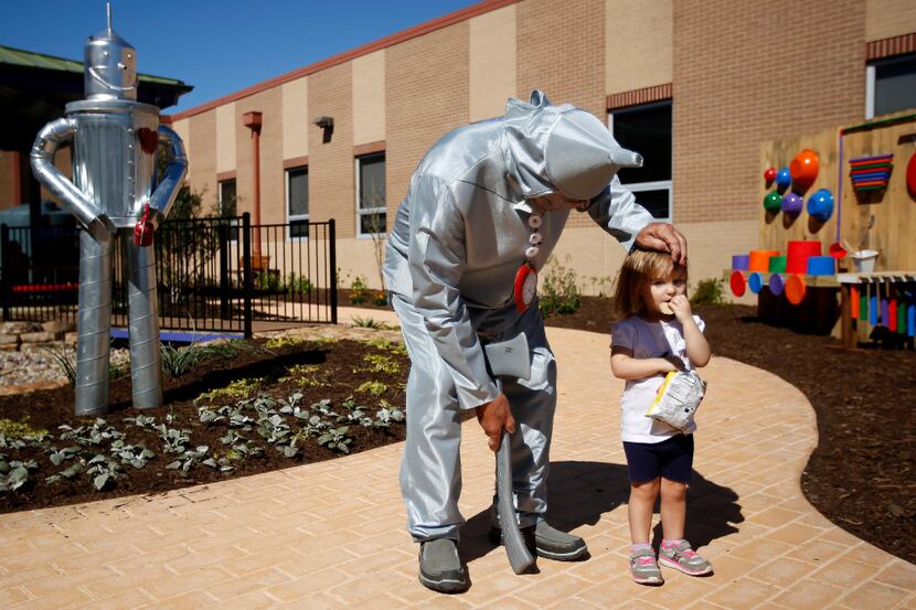 Bob Harvey, dressed as the Tin Man, says hello to his great-granddaughter Clementine Tarver,...