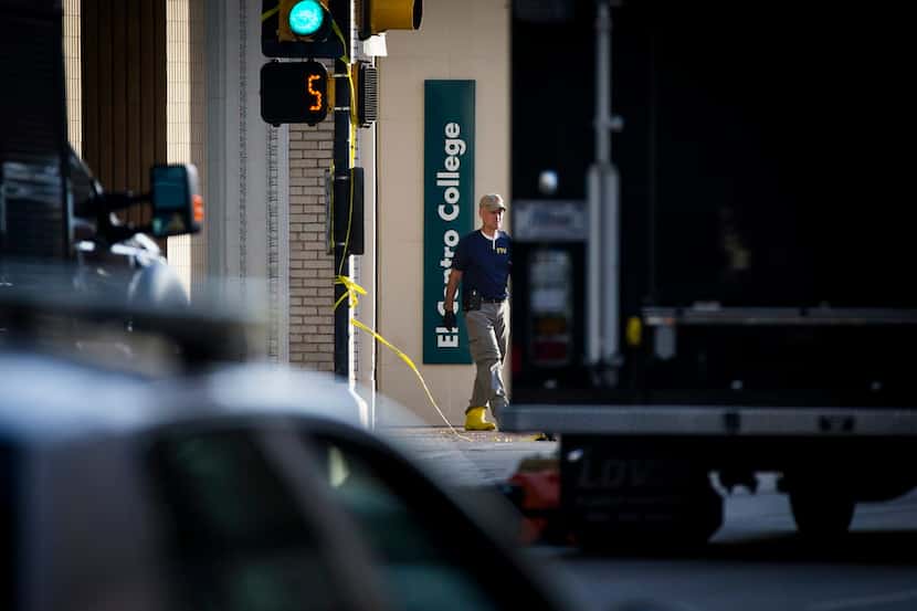 FBI personnel worked Sunday near an entrance to El Centro College in the area cordoned off...