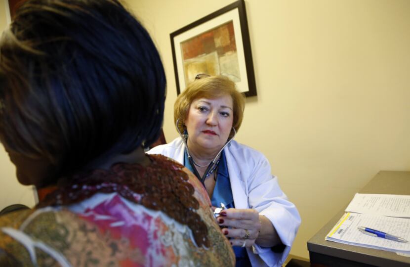 Nurse practitioner Sandy McCoy (right) examines Chautauqua Edwardson in McCoy's Dallas office.