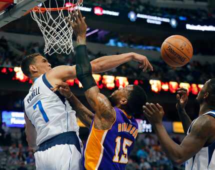 FILE - Dwight Powell (7) rejects a shot by Lakers forward Thomas Robinson (15) during the...