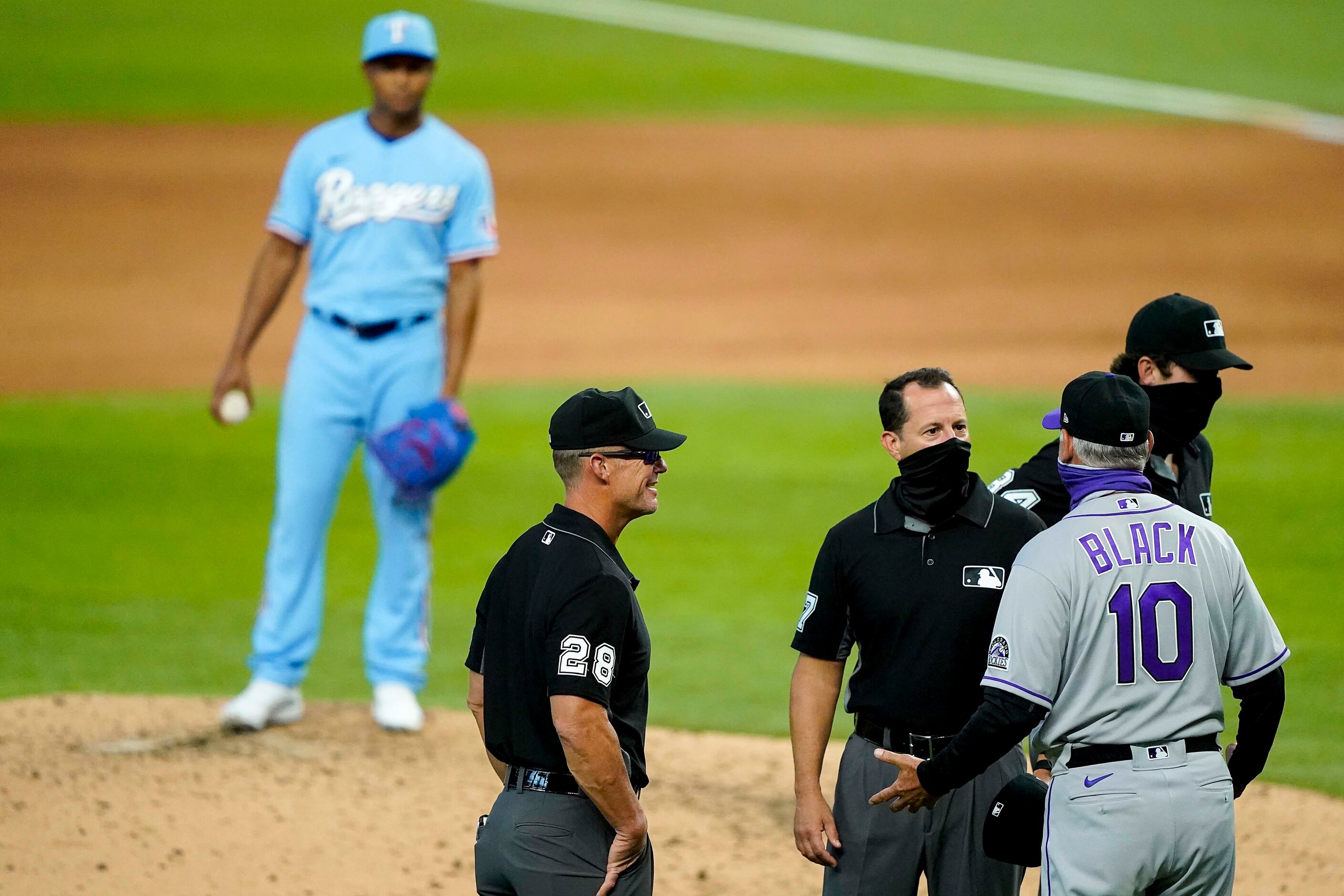 Texas Rangers pitcher Jose Leclerc looks on as Colorado Rockies manager Bud Black argues a...