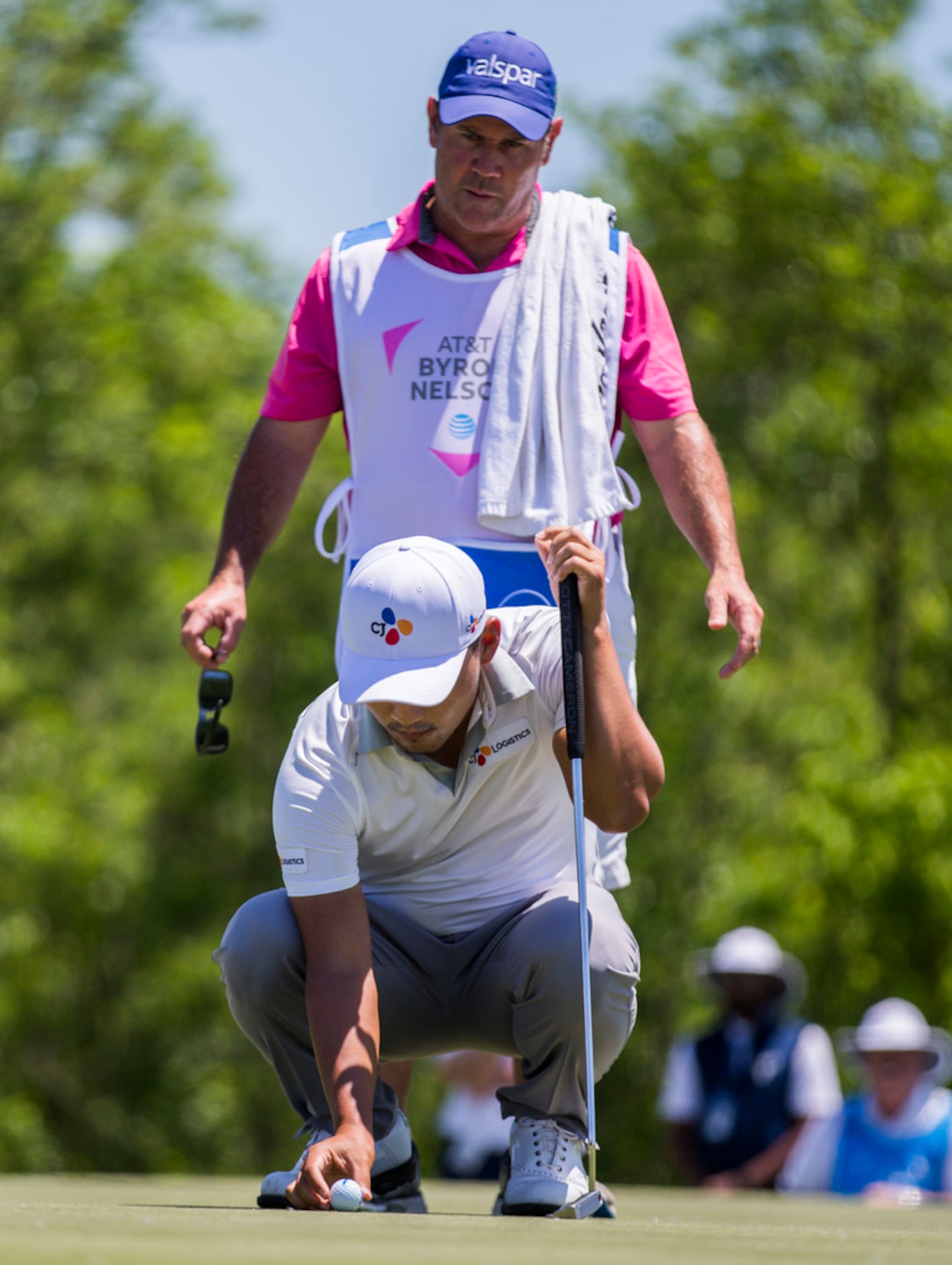 Sung Kang lines up a shot on hole 3 with his caddie, Jason Shortall,  during round 4 of the...