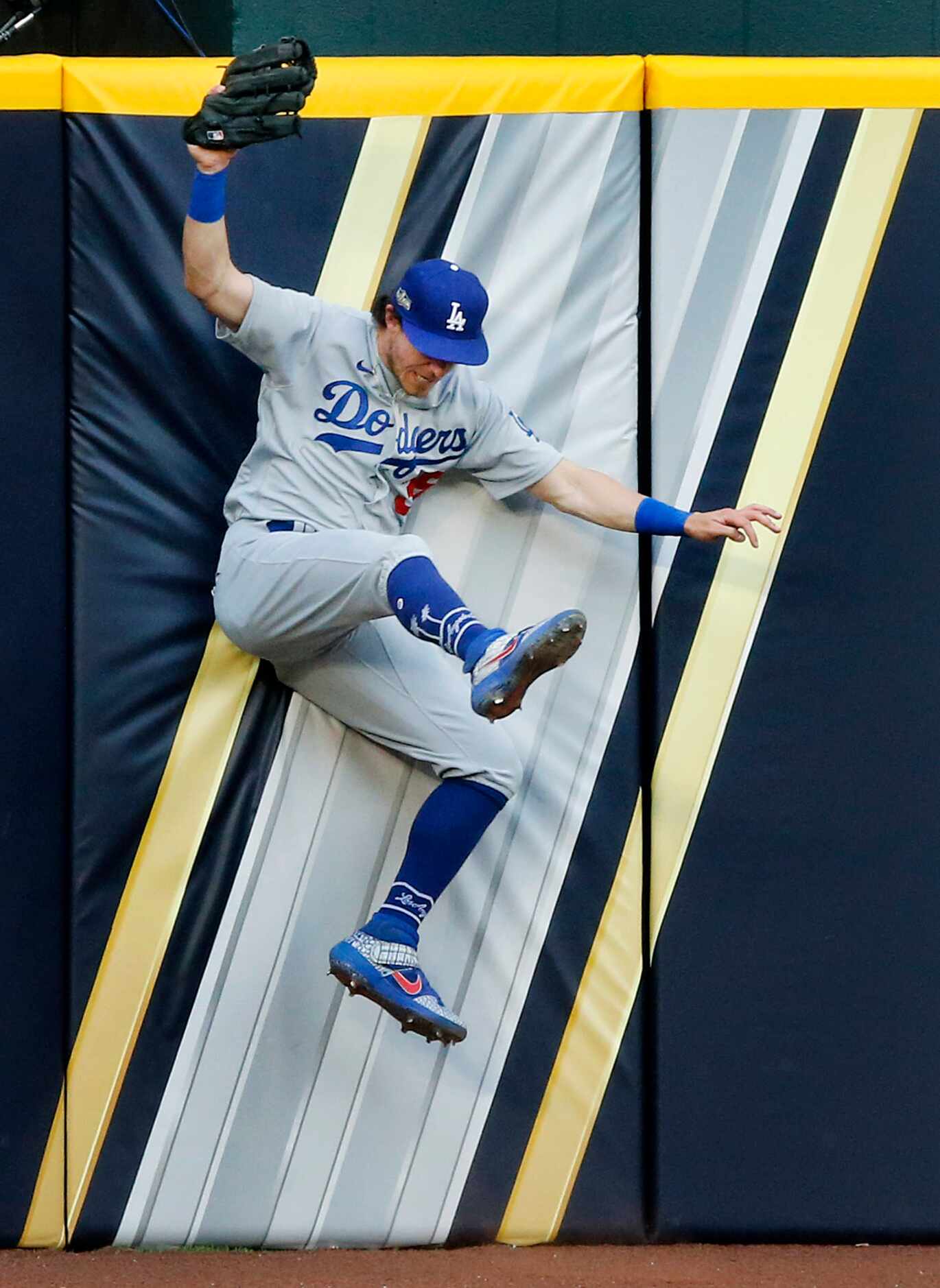 Los Angeles Dodgers center fielder Cody Bellinger (35) crashes against the wall as he caught...