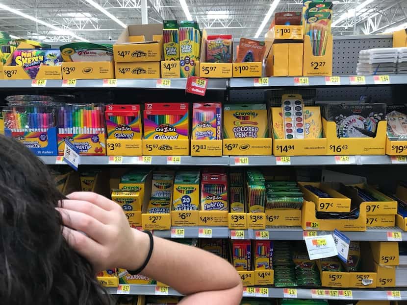 Morning News writer Lauren Fox hunts for school supplies at Walmart in Dallas on Wednesday,...