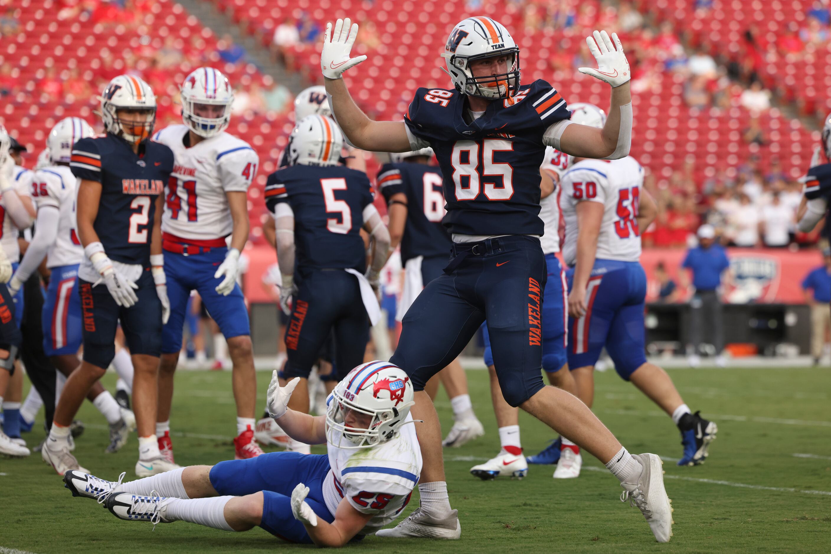 Wakeland High School’s Riordan Tripp (85) throws his hands up in the air as the referee...