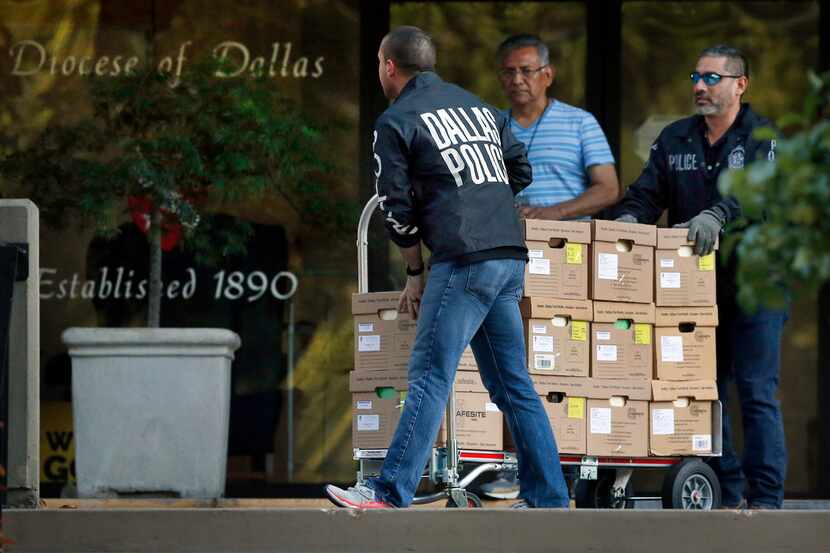 Dallas police officials carted out boxes from a raid on the Catholic Diocese of Dallas on...