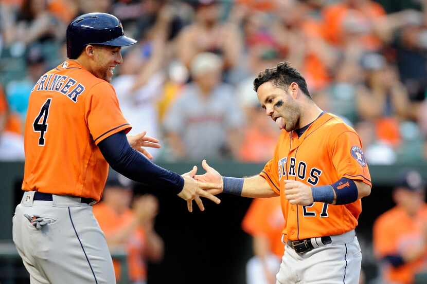 BALTIMORE, MD - AUGUST 21:  George Springer #4 and Jose Altuve #27 of the Houston Astros...