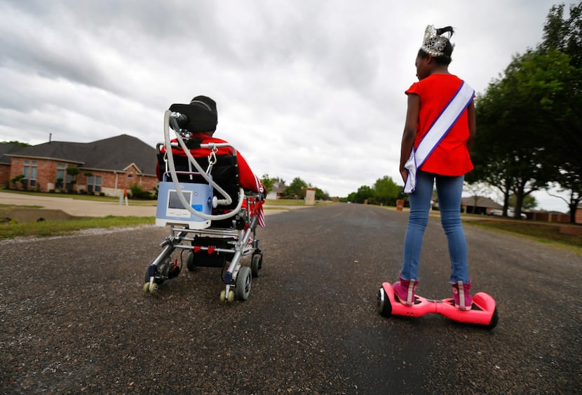 Rickey Dixon, in his wheelchair, and his daughter Alana, who wore a beauty pageant crown and...