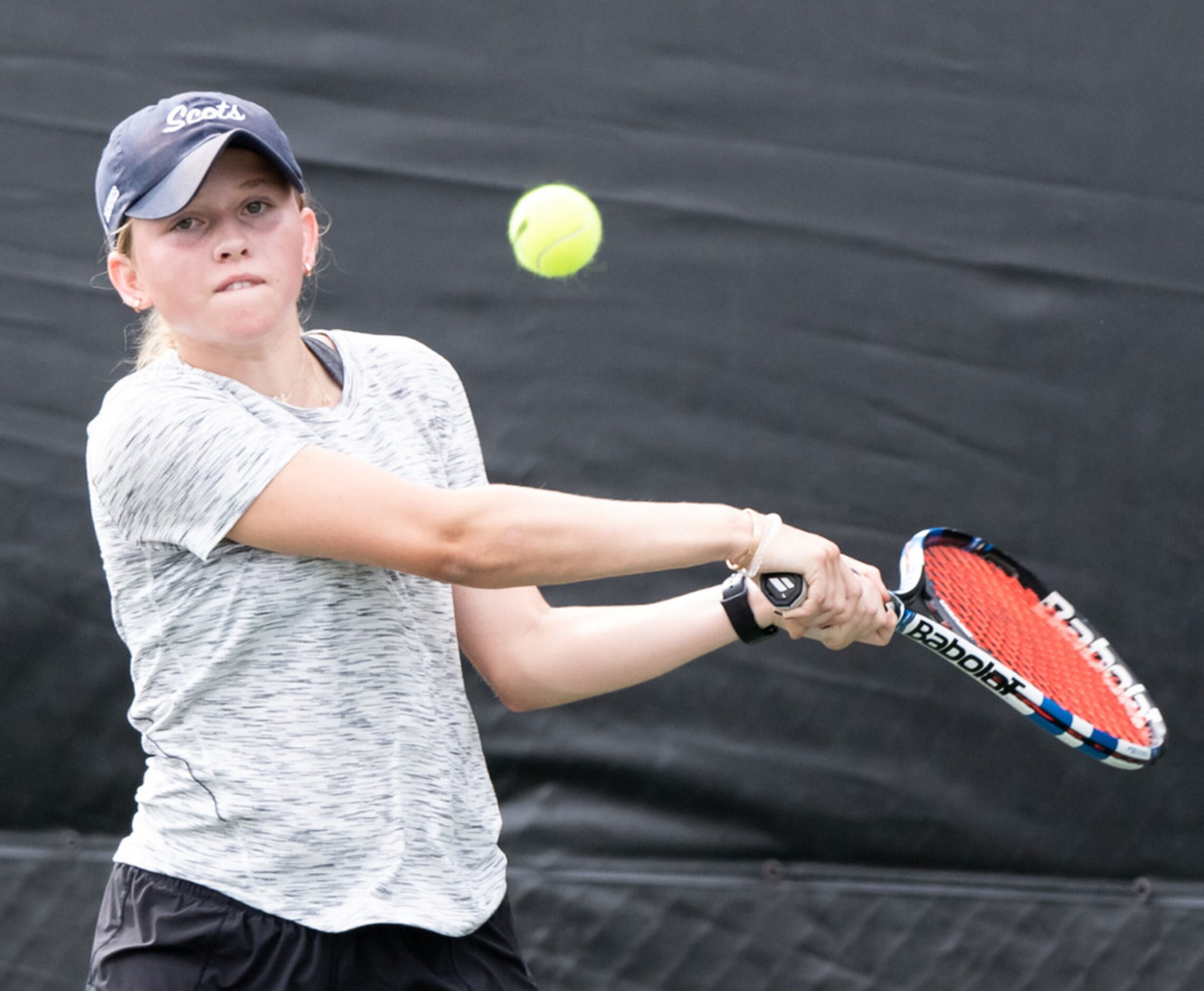 Highland Park's Jourdan Krueger returns the ball in a singles match against Colleyville...