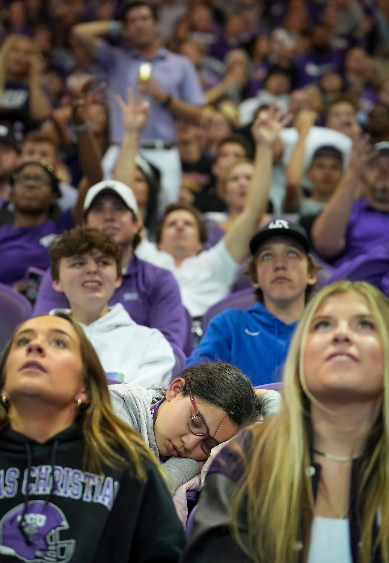 April Garcia, 11, naps in the stands as TCU fans to a first half Georgia touchdown during a...